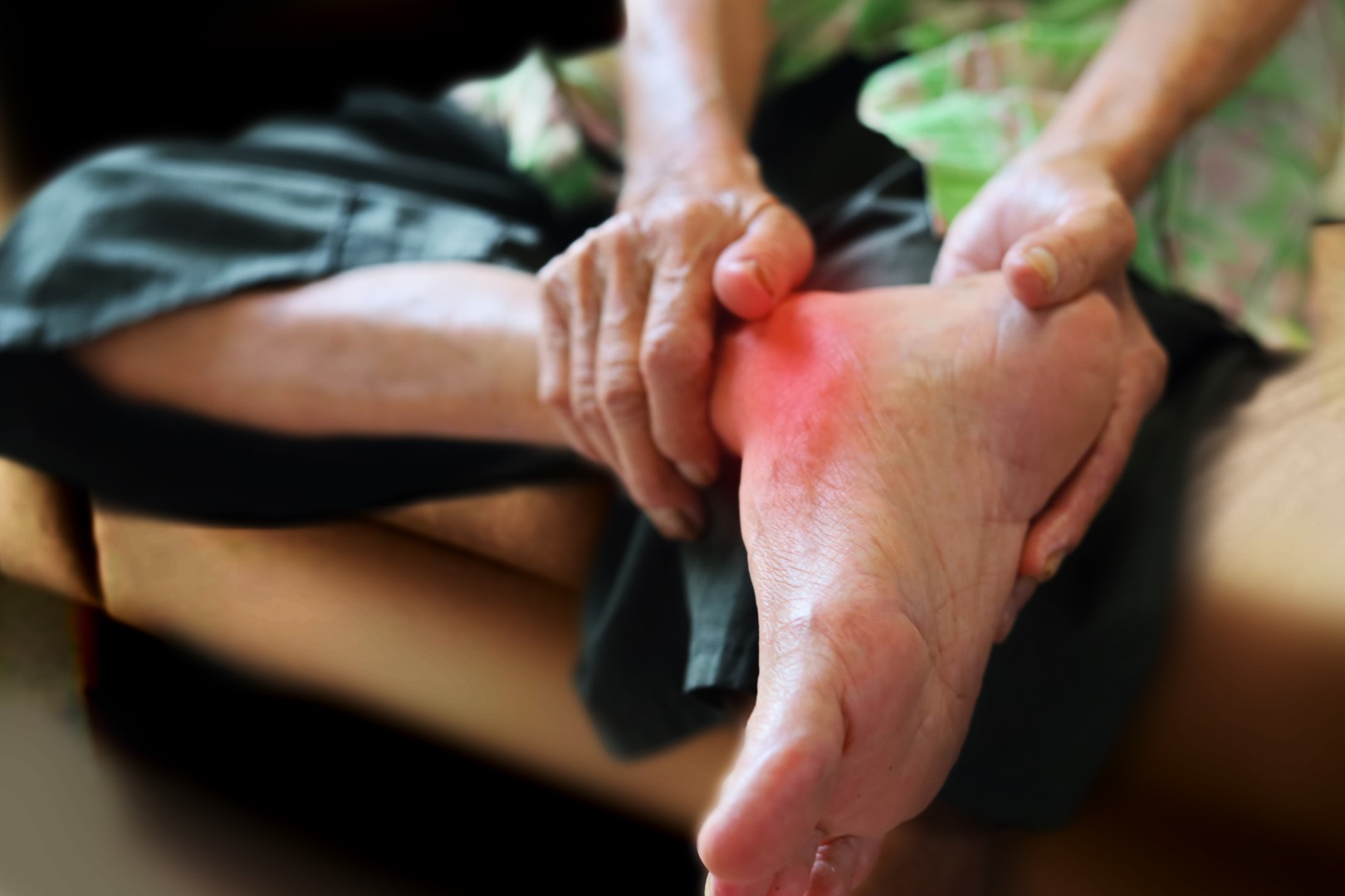 image of man holding foot with arthritic joints